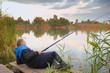 man fishing on the lake