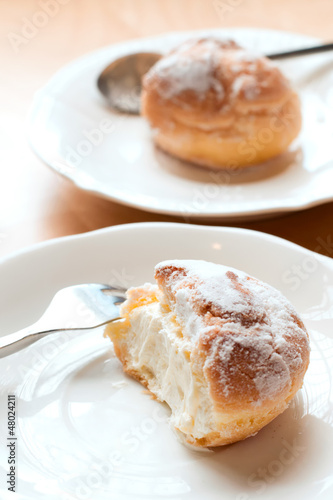Photo: Choux pastry cream puffs on white plate Choux pastry cream puffs on white plate