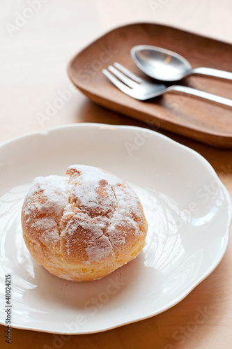 Photo: Choux pastry cream puffs on white plate Choux pastry cream puffs on white plate