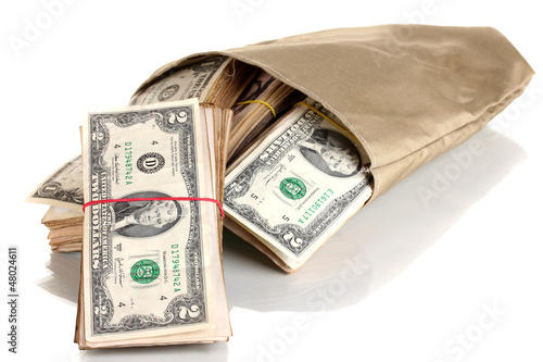 Photo: Bag with stacks of dollars isolated on white Bag with stacks of dollars isolated on white