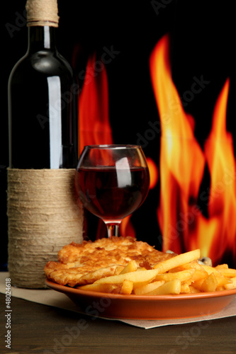 Photo: Roast chicken cutlet with french fries, glass of wine Roast chicken cutlet with french fries, glass of wine