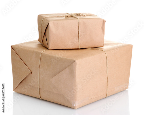 Photo: parcels boxes with kraft paper, isolated on white parcels boxes with kraft paper, isolated on white