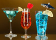 Alcoholic cocktails with ice on darck orange background