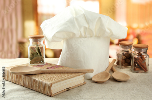 Photo: Chef's hat with spoons on table in kitchen Chef's hat with spoons on table in kitchen