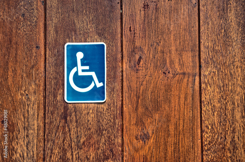 Photo: handicap sign on wooden background handicap sign on wooden background