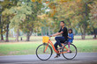 Photo: Brother and sister cycling bicycle at the park Brother and sister cycling bicycle at the park