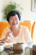 Senior Asian Woman dining