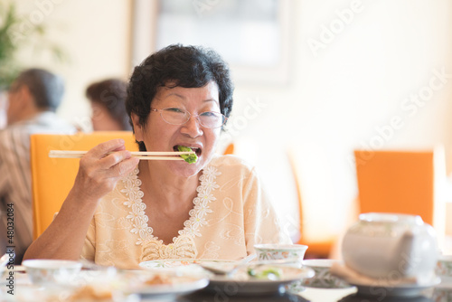 Photo: Senior Asian Woman eating vegetable Senior Asian Woman eating vegetable