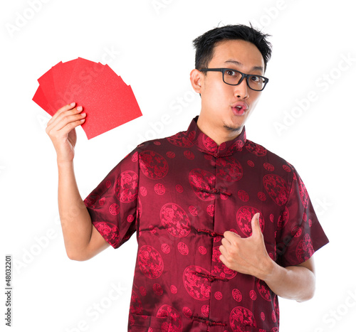 Photo: Shocked Asian Chinese man holding many red packets Shocked Asian Chinese man holding many red packets