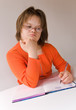 A girl with down syndrome writing.
