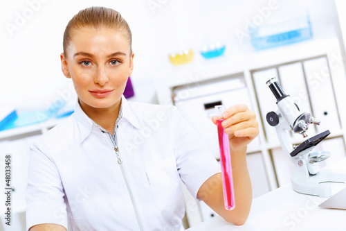 Photo: Young female scientist working in laboratory Young female scientist working in laboratory
