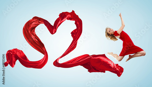 Photo: Dancing young woman with flying fabric Dancing young woman with flying fabric