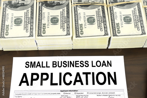 Photo: Approved small business loan application form and money Approved small business loan application form and money
