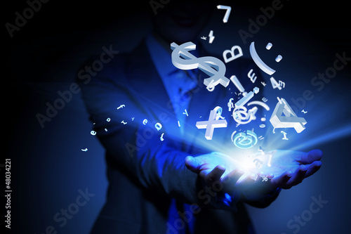 Photo: Business woman with financial symbols around Business woman with financial symbols around