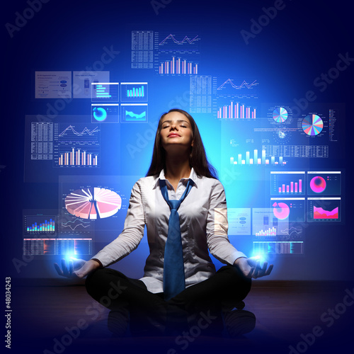 Photo: Business woman with financial symbols around Business woman with financial symbols around