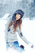 Photo: Girl playing with snow in park Girl playing with snow in park