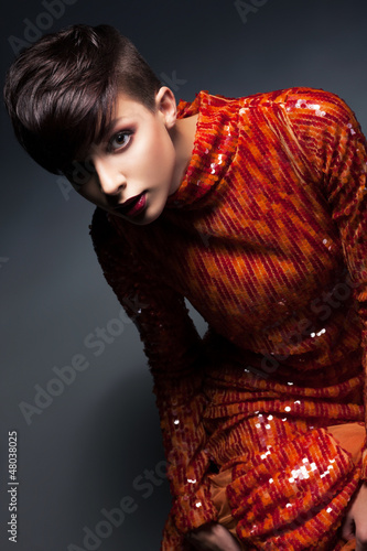 Photo: Charm. Chic Young Woman in Red Evening Gown posing Charm. Chic Young Woman in Red Evening Gown posing