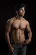 Foto: Healthy muscular young man on dark background. Healthy muscular young man on dark background.