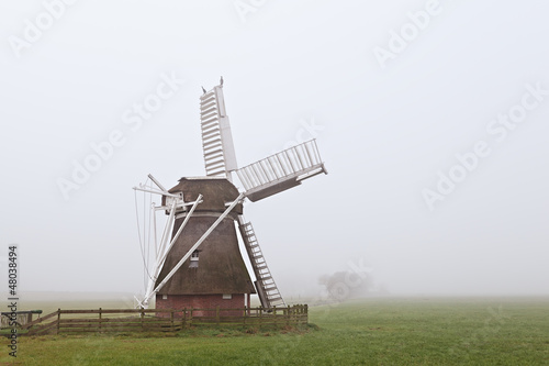 Photo: wooden windmill in fog wooden windmill in fog