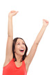Excited woman with arms raised
