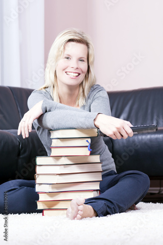 Photo: Beautiful blonde woman in the book is based on the remote contro Beautiful blonde woman in the book is based on the remote contro