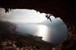 Silhouette of a rock climber at sunset. Kalymnos Island, Greece.