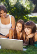 Photo: Happy young student girls using a laptop Happy young student girls using a laptop