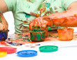 Little boy is playing with paints