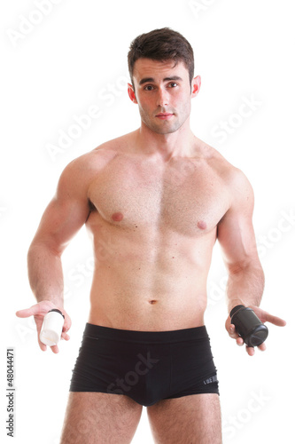 Photo: sexy male body builder holding a boxes with supplements on his b sexy male body builder holding a boxes with supplements on his b