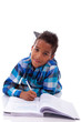 Little african boy lying down on the floor and reading book