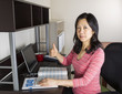 Photo: Positive Mature Asian Doing Personal Income Taxes Positive Mature Asian Doing Personal Income Taxes