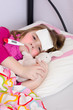 Sick young girl under temperature measurement