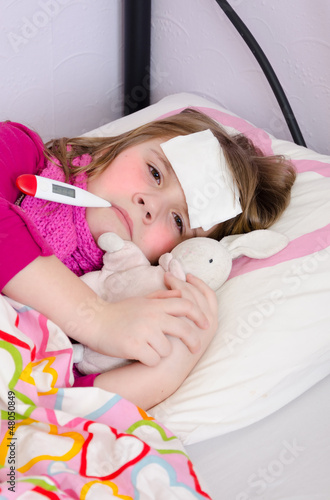 Photo: Sick young girl under temperature measurement Sick young girl under temperature measurement