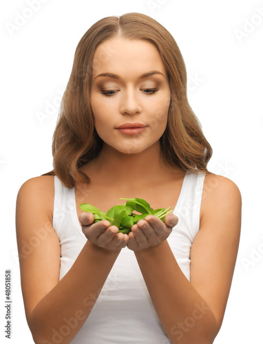 Photo: woman with spinach leaves on palms woman with spinach leaves on palms