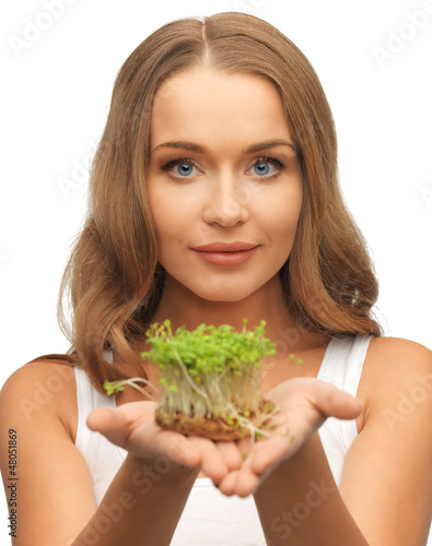 Photo: woman with green grass on palms woman with green grass on palms