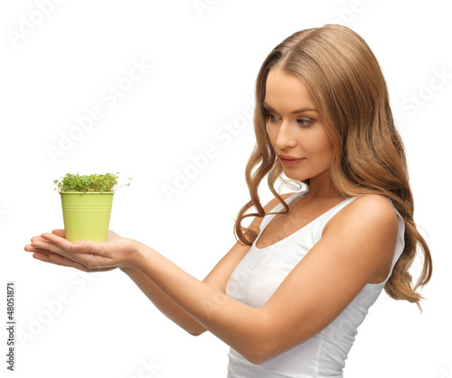 Photo: woman with green grass in pot woman with green grass in pot