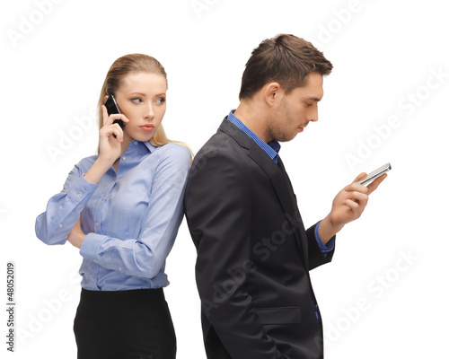 Photo: man and woman with cell phones man and woman with cell phones