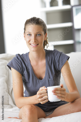 Photo: Cute young lady with a cup of coffee Cute young lady with a cup of coffee