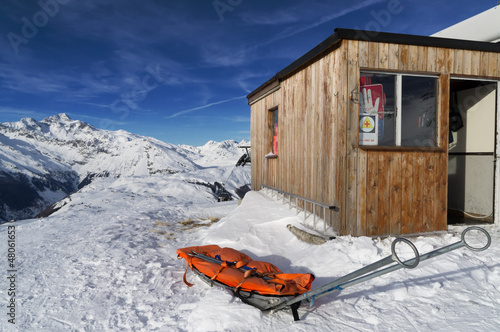 Photo: alpine rescue in the snow on mountain alpine rescue in the snow on mountain