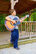 Boy Playing Guitar Outdoors