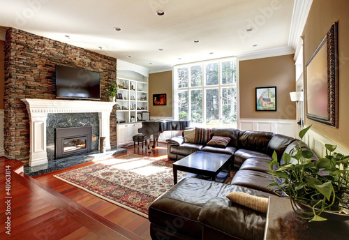 Photo: Luxury living room with stobe fireplace and leather sofas. Luxury living room with stobe fireplace and leather sofas.