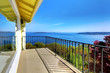 House balcony with water amazing view and metal railings.