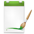 Green brush and blank page of a notebook for your message