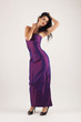 Photo: Portrait of sensual brunette caucasian woman with purple dress. Portrait of sensual brunette caucasian woman with purple dress.