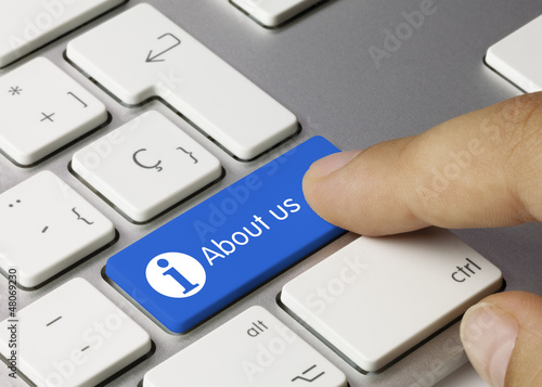 Photo: About us keyboard key. Finger About us keyboard key. Finger
