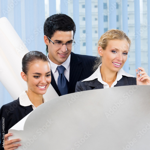 Photo: Three businesspeople working at office Three businesspeople working at office