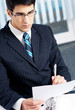 Portrait of reading businessman working at office
