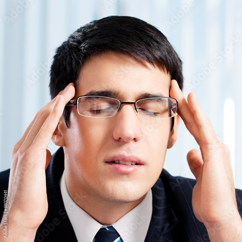 Photo: Thinking, tired or ill with headache businessman Thinking, tired or ill with headache businessman