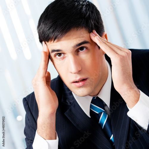 Photo: Thinking, tired or ill with headache businessman Thinking, tired or ill with headache businessman