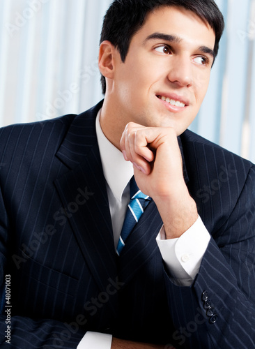 Photo: Portrait of thinkihg businessman at office Portrait of thinkihg businessman at office